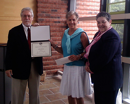 Pat, center, accepts her Norman Mailer CICC Writing Award