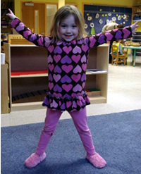 Child taking yoga class