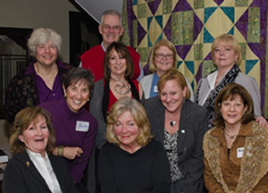 Past and present Board of Directors with the WE CAN 10th anniversary Quilt