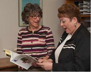 Mary Jaynes conferring with a WE CAN program participant 